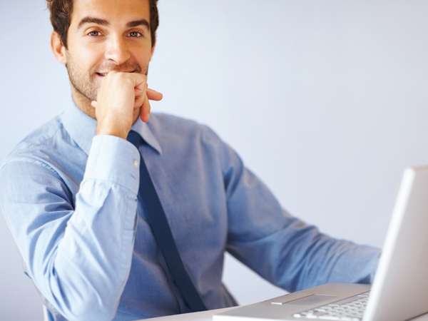 Portrait of young confident business man with laptop