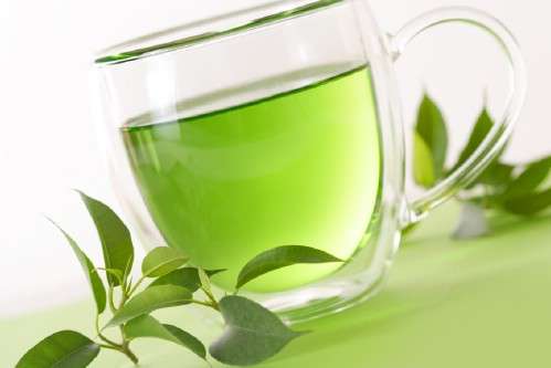 healthy green tea cup with tea leaves