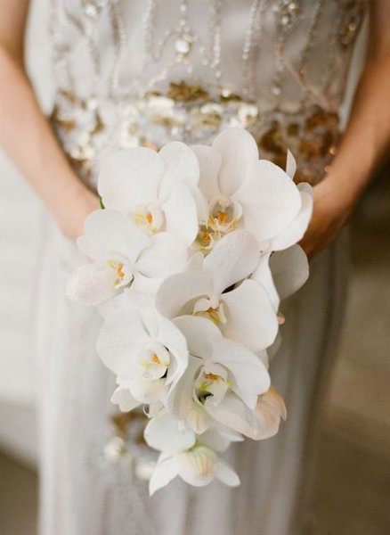 02-an-elegant-and-refined-white-orchid-wedding-bouquet-with-a-slight-cascade-for-a-refined-bride.jpg