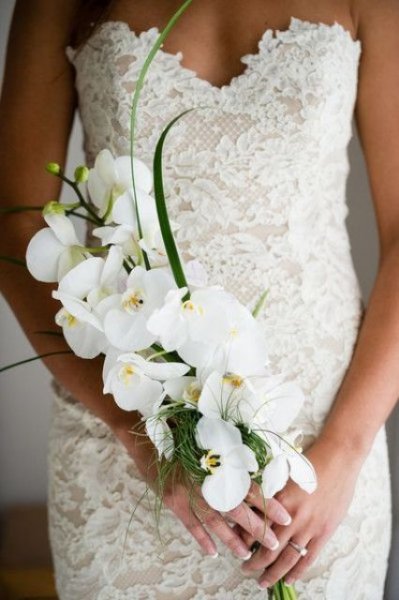 06-a-sophisticated-yet-very-simple-bridal-bouquet-of-white-orchids-and-some-greenery.jpg