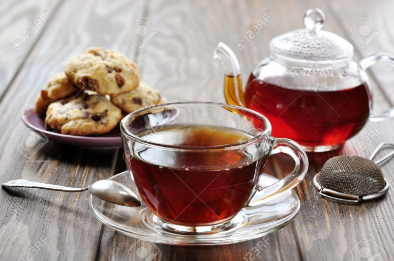 18681428-Cup-of-tea-with-teapot-and-cookies-on-wooden-background-Stock-Photo.jpg