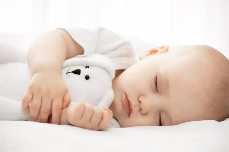 baby-and-small-teddy-sleeping1.webp