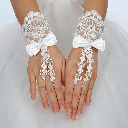 Wristlength_Fingerless_Ivory_Lace_Wedding_Gloves_with_Satin_Bow.jpg