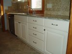 $Merillat Whitebay II arch doors with granite countertop and natural stone backsplash (3).JPG