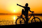 $1497129-887437-silhouette-girl-with-bicycle-nera-the-sea-showing-thumbs-up.jpg