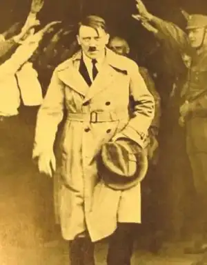$Adolf_Hitler_walking_out_of_Brown_House_after_1930_elections.webp